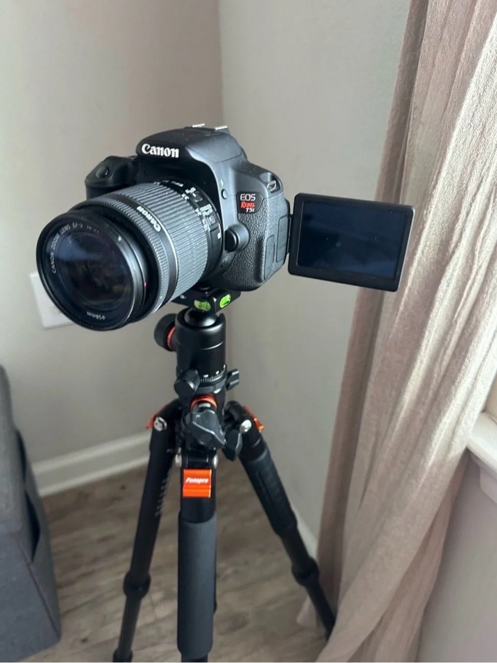 Canon Black DSLR Camera with Rotating LCD and Black Tripod